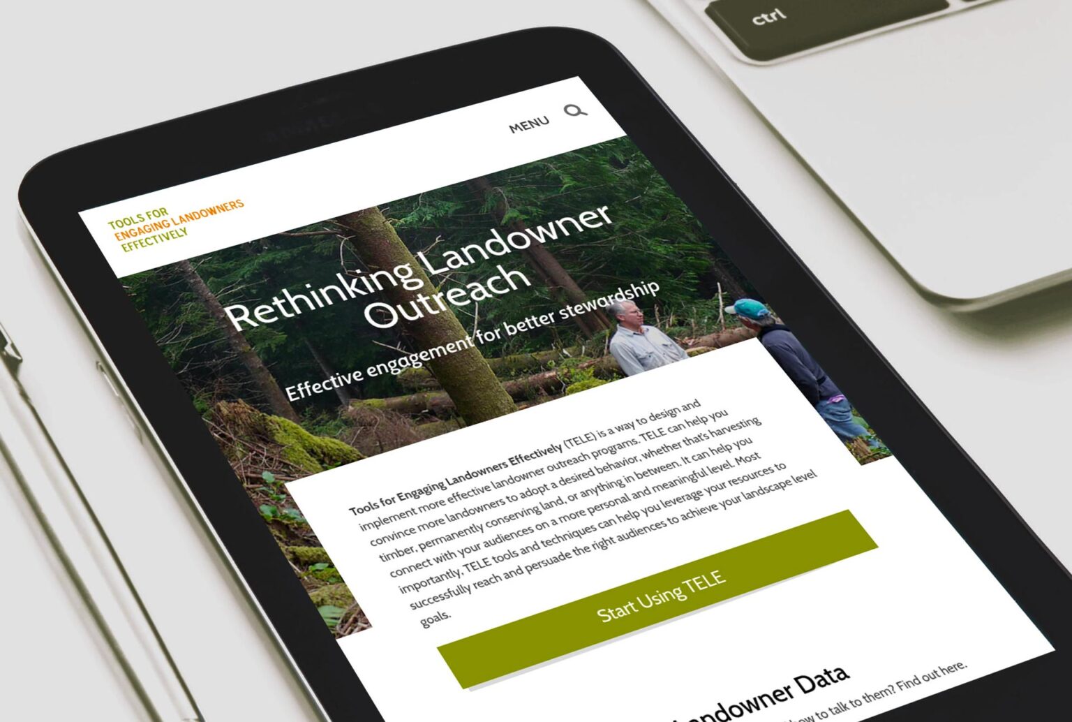 ipad tablet on desktop showing the home page of the TELE website